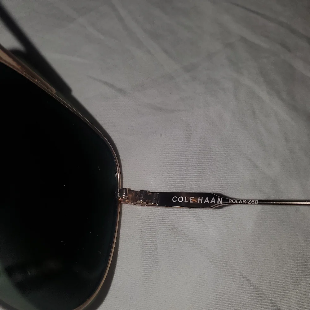 Cole Haan gold aviator sunglasses with dark lenses. Polarized.